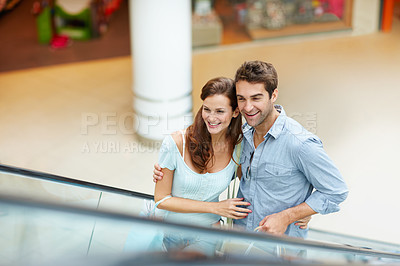 Buy stock photo Smile, shopping and escalator with couple in mall for retail purchase, anniversary gift and support. Store discount, customer promotion and love with man and woman with bags for boutique shopper