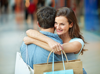 Buy stock photo Couple, hug and care in mall with shopping bag, bonding together or gratitude for retail purchase. Happy, people dating and embrace with relationship, love customer experience or thankful for partner