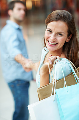 Buy stock photo Portrait, mall or happy woman with shopping bag for purchase, payment or buying spree. Female person, consumer or shopper holding hands with partner or smile in commercial center for discount or deal