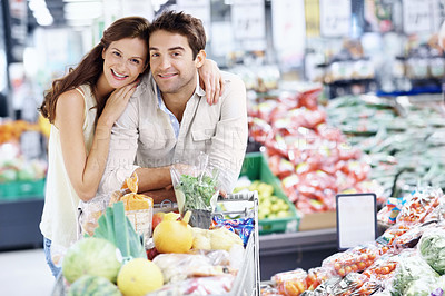 Buy stock photo Portrait, smile and couple with cart in grocery store, supermarket and shopping on weekend. Happy, relationship and man with woman with embrace, food and produce for discount, sale and bonding
