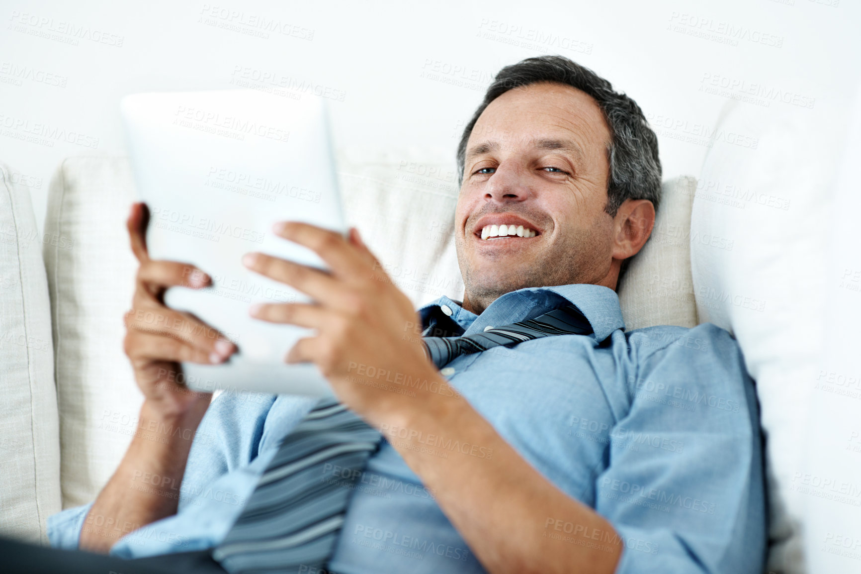 Buy stock photo Tablet, relax and portrait of businessman on sofa in home with remote work for finance report with email. Digital technology, happy and male financial manager with review on investment plan in house.