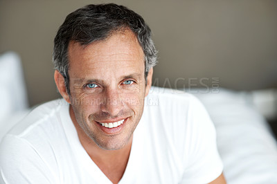 Buy stock photo Relax, man and smile in portrait on bed for peaceful morning, comfortable rest and wellness. Calm, mature person and happy in home for weekend break, positive attitude or unwind on day off in bedroom