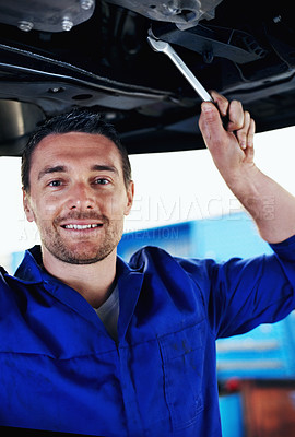 Buy stock photo Car, mechanic and smile with man in garage for automobile maintenance, repair or service. Industry, portrait and undercarriage with happy engineer in vehicle workshop for professional inspection