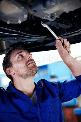 Buy stock photo Wrench, technician and man under car for maintenance, fix and problem solving at workshop. Tools, auto mechanic and person with vehicle for service, transmission inspection or repair at garage