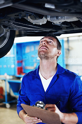 Buy stock photo Mechanic, man and car service with clipboard in garage for oil leak, suspension system or compliance. Technician, mature person and checklist for vehicle inspection, brake safety or auto repair quote