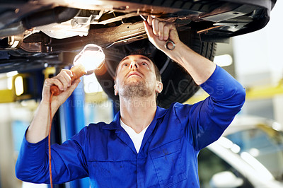 Buy stock photo Car, lamp and maintenance with man in garage for vehicle inspection, repair or service. Light, tool and undercarriage with mechanic in automobile workshop for check, compliance or engineering job