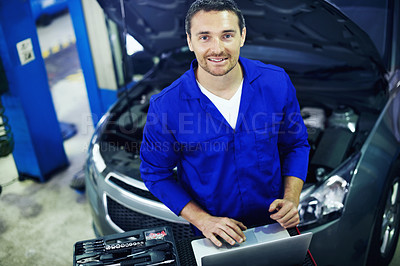 Buy stock photo Portrait, man and mechanic in garage with laptop, smile and software for engineering career. Above, technology and workshop for car diagnostics, maintenance and auto or vehicle service or tuning