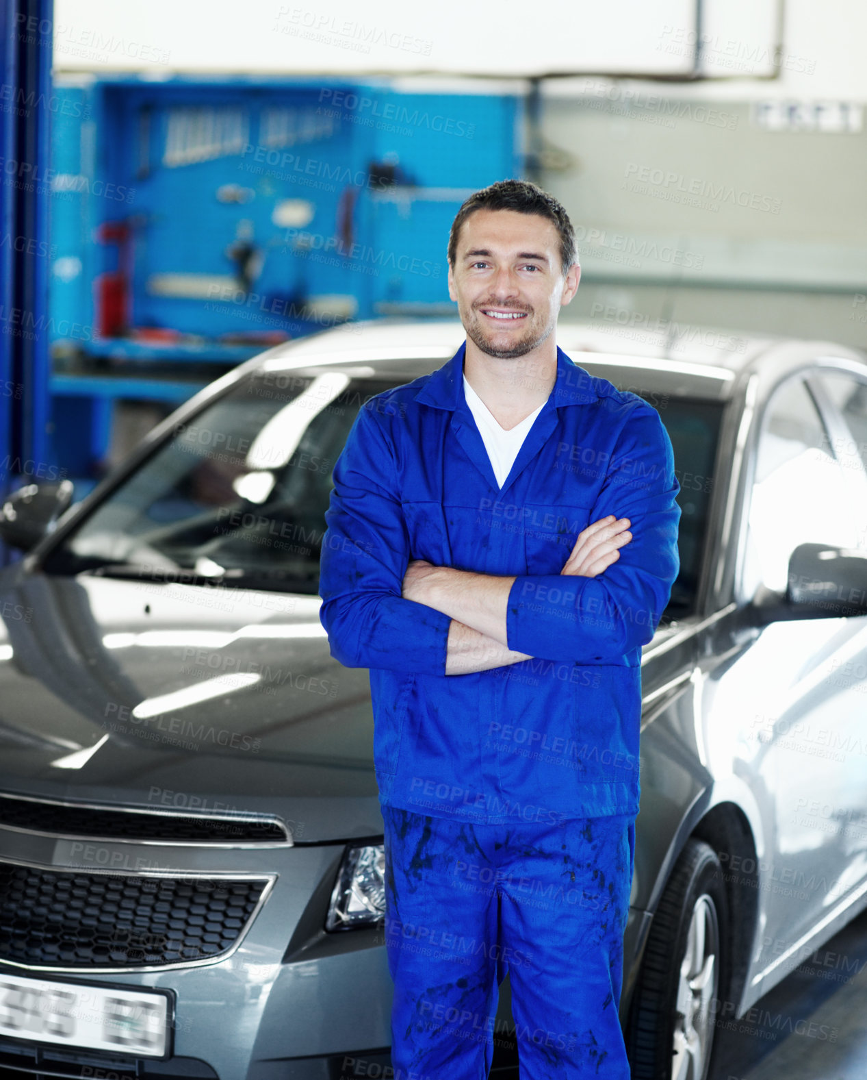 Buy stock photo Crossed arms, happy and portrait of mechanic in workshop with confidence for repairs on car. Man, professional and automotive technician with pride for vehicle maintenance at garage in London.