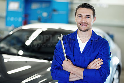 Buy stock photo Portrait, man and car mechanic in workshop with arms crossed, wrench or repair shop for small business. Confident, person and motor service technician with startup, tools and maintenance for vehicle.
