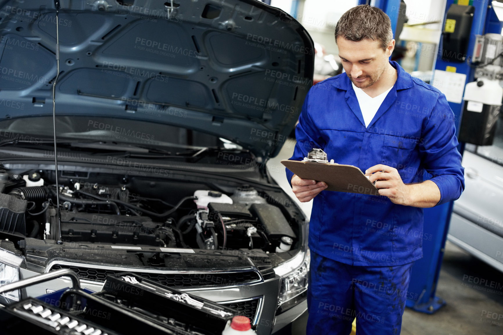 Buy stock photo Man, engineer and inspection on clipboard for car at workshop  for notes, report or repair services. Person, technician or mechanic with vehicle, checklist and maintenance with career at auto garage