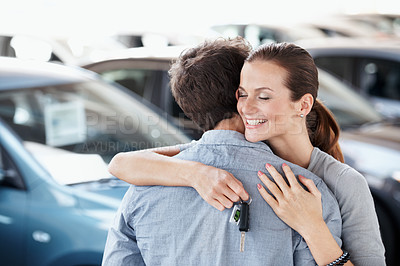 Buy stock photo Couple, hug and happy at car dealership with keys for purchase, buying and gift for anniversary. Man, woman and excited for luxury present, gratitude or showroom for customer or client milestone