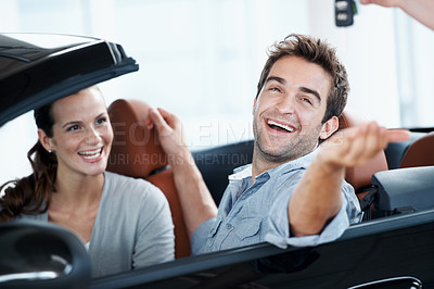 Buy stock photo Couple, excited and smile with keys, new car and appointment for dealership purchase and celebration. Loan approval, showroom and people shopping for vehicle, rental or investment for transportation