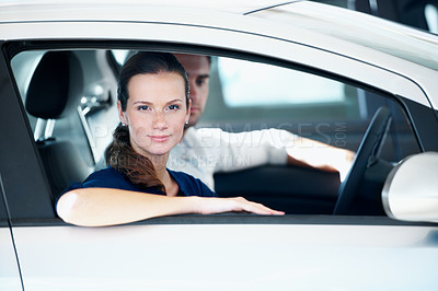 Buy stock photo Dealership, portrait and sale with woman in car for choice, automobile purchase or test drive. Retail, serious and window with customer couple in showroom for decision, shopping or vehicle finance