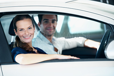 Buy stock photo Dealership, portrait and sale with happy couple in car together for choice, purchase or test drive. Retail, smile and window with customer people in showroom for decision, shopping or vehicle finance