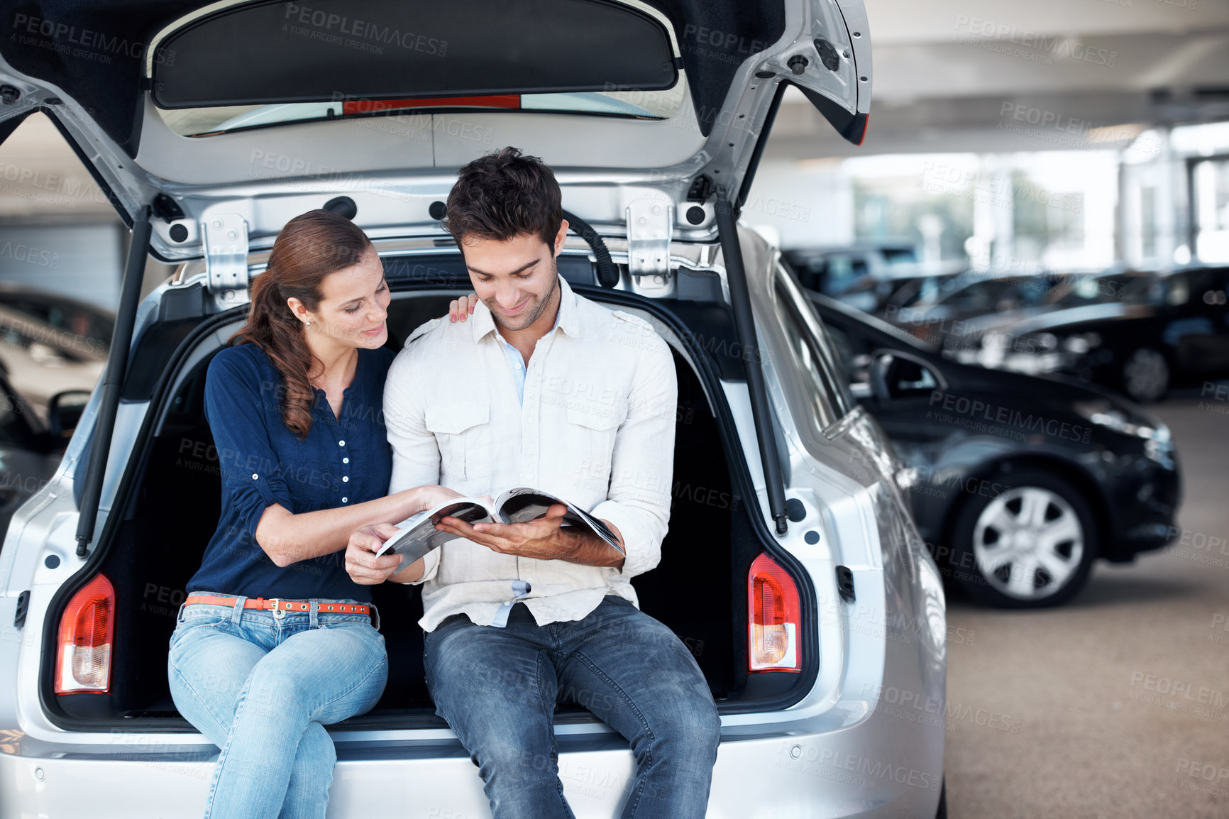 Buy stock photo Selection, car or couple at dealership with brochure, option guide or automobile choice in showroom. Smile, relationship or people with leaflet, decision together or purchase info with vehicle review