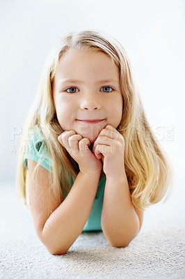 Buy stock photo Portrait of a little blonde girl lying in the carpet at home