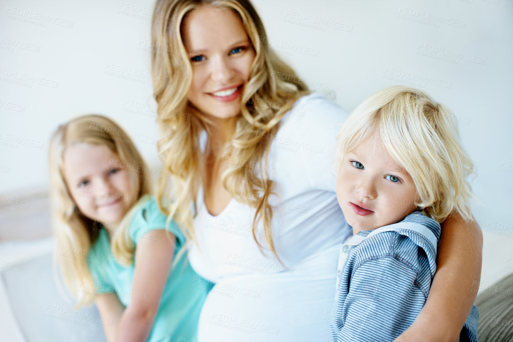 Buy stock photo Happy, pregnancy and mom with children in home for bonding, connection and relationship. Family, portrait and pregnant woman with kids for embrace, affection and love for parenting, maternity or care