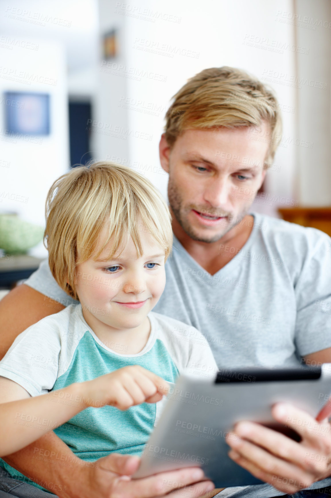 Buy stock photo Tablet, reading and father with son on sofa in home for education app, smile or learning game. Search, child development website and subscription with man and kid in living room for bonding and relax