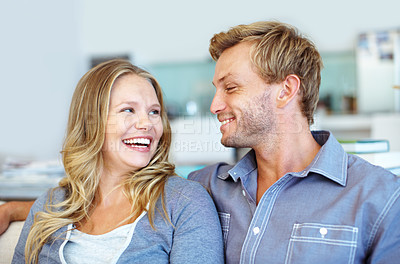 Buy stock photo Cute young couple relaxing together on the sofa at home