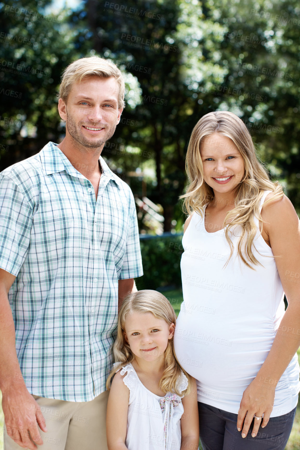 Buy stock photo Happy, father and child in nature with pregnant woman, love and summer holiday for bonding together. Portrait, parents and smile at park with daughter, maternity and weekend break for family vacation