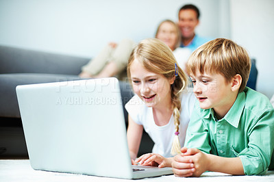 Buy stock photo Children, siblings and play in house with laptop, knowledge game or bonding with parents supervision. Happy, kids relax and educational gaming in living room with computer, learning or entertainment.