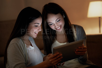 Buy stock photo Two teenage girls laughing about something on a digital tablet