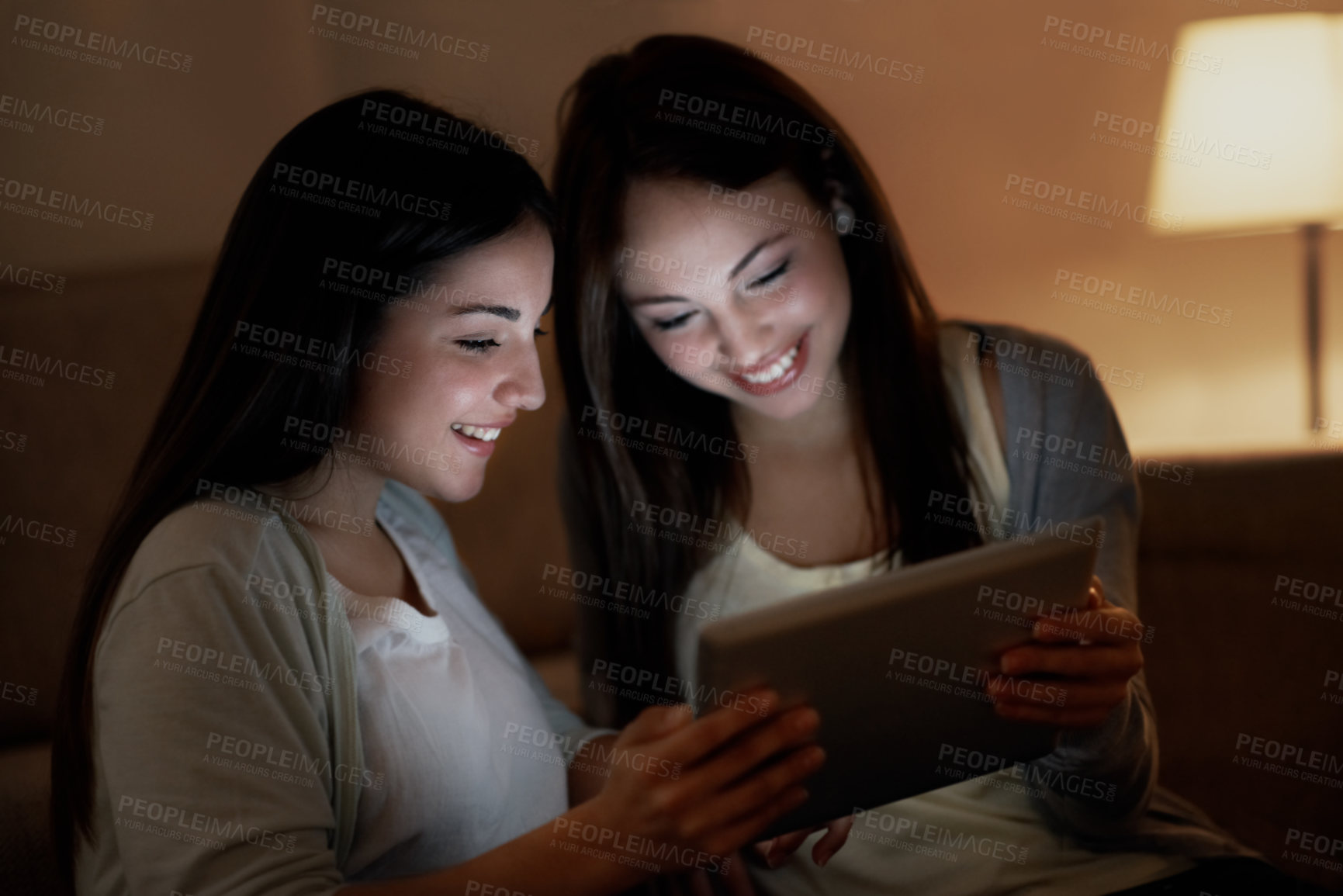 Buy stock photo Tablet, night and reading with sisters in home for social media post, teenagers and bonding. Late streaming, entertainment and online subscription with girl in house for connection and weekend break