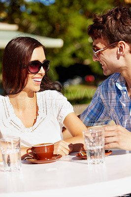 Buy stock photo Beautiful woman enjoying a coffee date with her boyfriend at an outdoor cafe