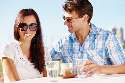 Buy stock photo Beautiful woman enjoying a coffee date with her boyfriend at an outdoor cafe