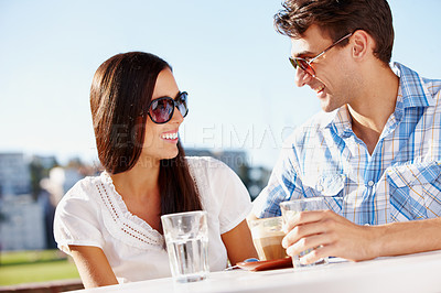 Buy stock photo Beautiful woman enjoying a coffee date with her boyfriend at an outdoor cafe