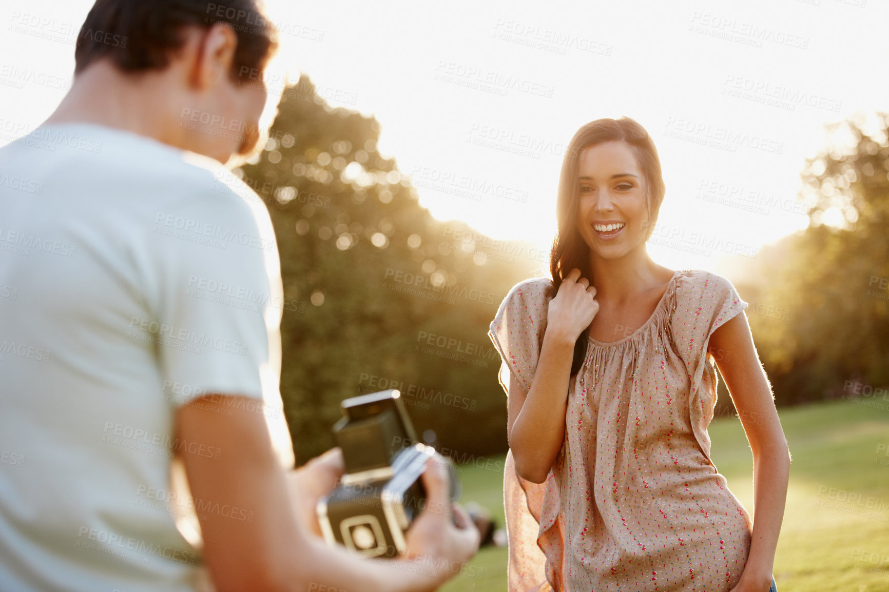 Buy stock photo Camera, smile and love with couple in park for film photography, romantic relationships and support. Vintage gear, bonding and summer date with man and woman in nature for photoshoot and care