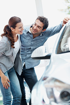 Buy stock photo Laugh, couple and shopping at car dealership, discussion and decision for automobile with partner. Showroom, man and woman with dream vehicle for purchase, funny joke or customers with transport
