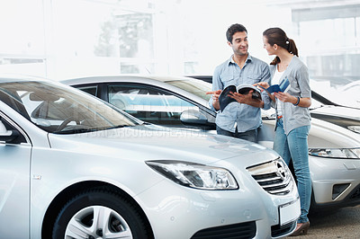 Buy stock photo Inspection, car or couple at dealership with pamphlet, selection or automobile catalog in showroom. Smile, relationship or people with book, review together or purchase guide in vehicle evaluation.