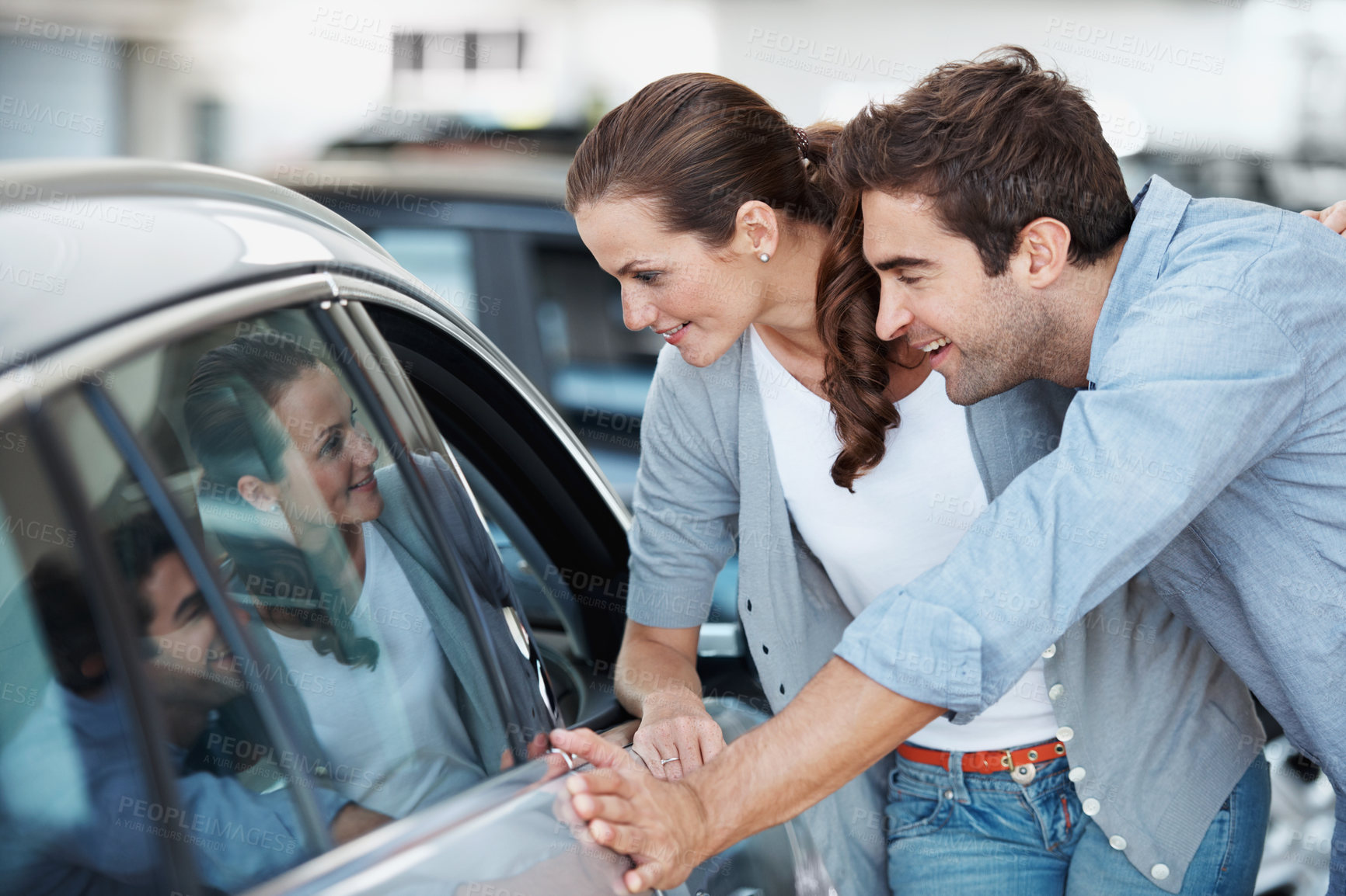 Buy stock photo Car, choice and shopping with happy couple in dealership together for decision or purchase. Buying, retail sale and satisfaction with people in showroom for consumerism, insurance or vehicle finance