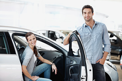 Buy stock photo Portrait, couple and customer at showroom with car, inspection and transport for test drive. Smile, people or satisfaction at dealership with vehicle, finance approval and collection of auto purchase