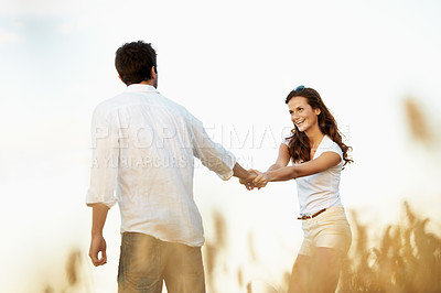 Buy stock photo Smile, holding hands and couple in wheat field for bonding, vacation or romance in countryside. Happy, man and woman in nature for weekend trip together with holiday, anniversary and playful travel