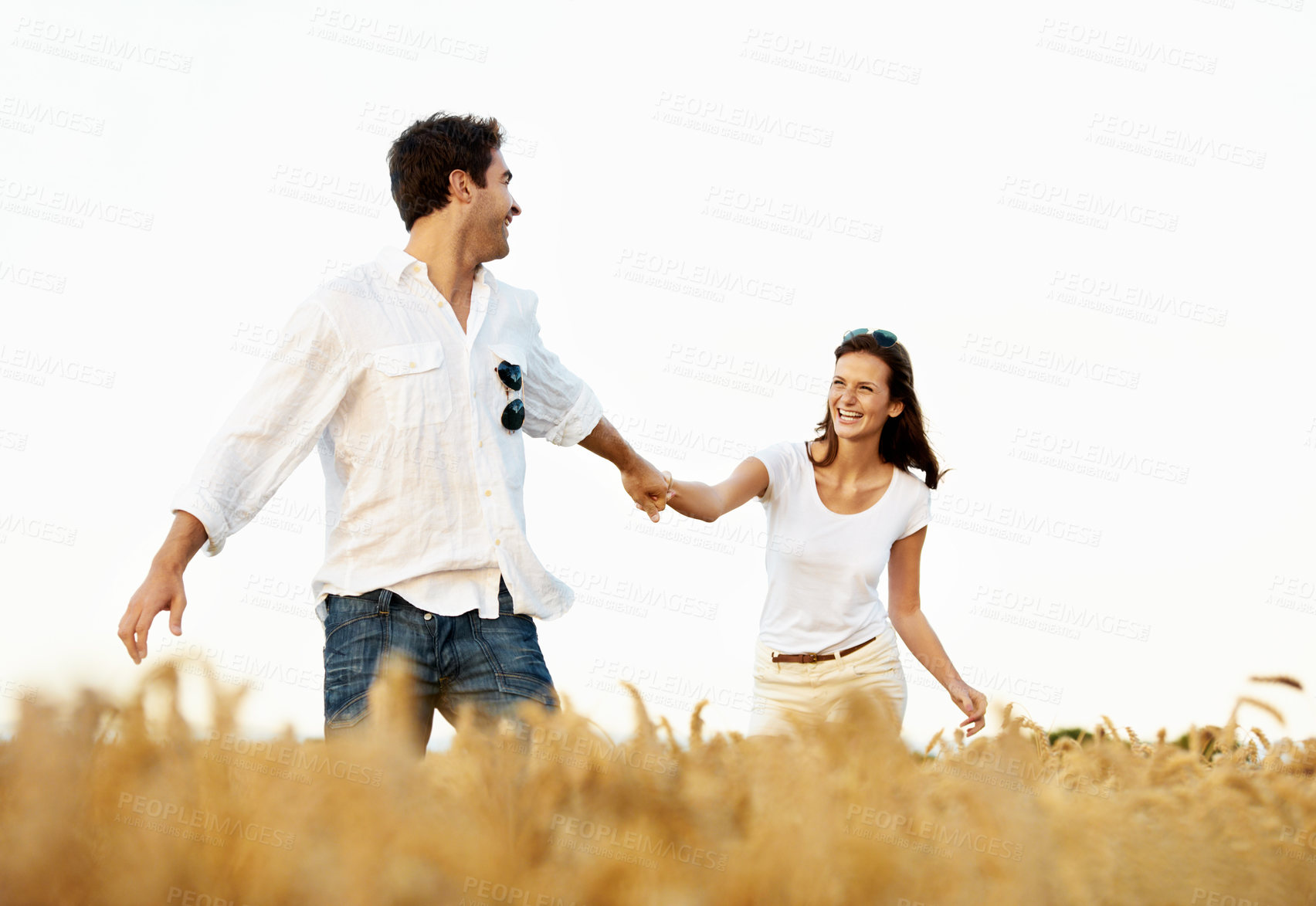 Buy stock photo Smile, couple and holding hands in wheat field for vacation, bonding or romance in countryside. Happy, man and woman in nature for weekend trip together with holiday, anniversary and playful travel