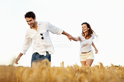 Buy stock photo Smile, couple and holding hands in wheat field for travel, bonding or romance in countryside. Happy, man and woman in nature for weekend trip together with holiday, anniversary and playful vacation