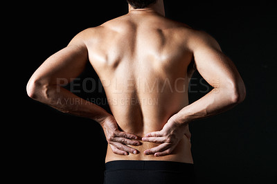 Buy stock photo Shirtless, massage and man in studio for back pain, inflammation or injury with arthritis. Fibromyalgia, sprain and male person by black background with muscle tension, accident or joint ache.