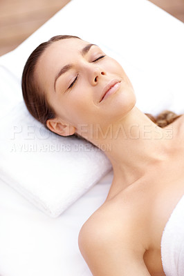 Buy stock photo Relaxed young woman lying on a spa bed with her eyes closed