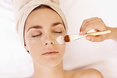 Buy stock photo Young woman receiving a face mask treatment at a spa