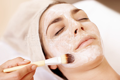 Buy stock photo Young woman receiving a face mask treatment at a spa