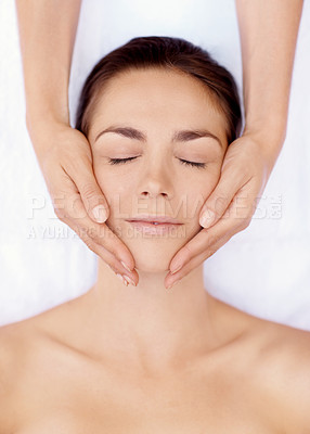 Buy stock photo Portrait of a beautiful woman receiving a facial massage during a spa day - closeup