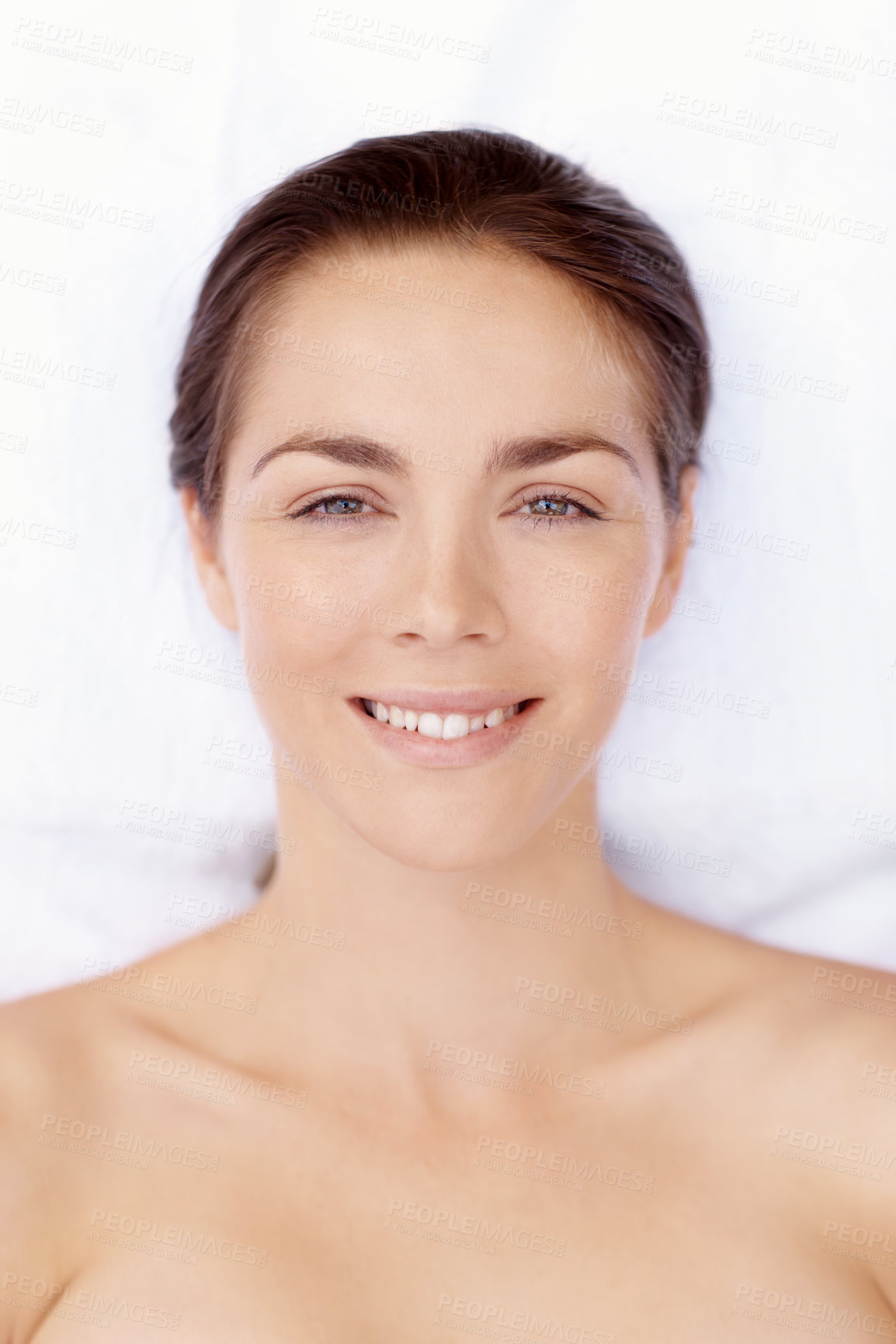 Buy stock photo Smile, portrait and massage table with woman in spa for skincare treatment, wellness and body care. Zen, beauty salon and hospitality with above of person in hotel for lodge, relax and calm therapy
