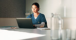 Healthcare, nurse and woman with laptop in clinic, administration and reading medical records on web. Health professional, online and person with tech for test results, info and research in hospital