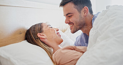 Buy stock photo Relax, smile or couple in bed with love, romantic moment or bonding together on weekend break. Chill, comfy or people in house with cuddle, partner care or tender connection in happy relationship.