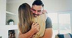 New home, happy couple and hug with key, property investment or support with partner in living room. Real estate goal, man and woman embrace in dream house, smile and purchase with mortgage success