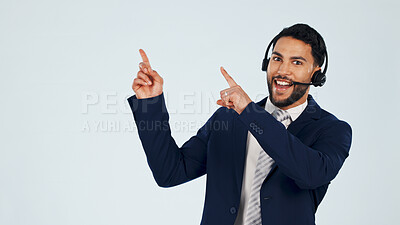 Buy stock photo Pointing, portrait and man in studio for call center, contact us and business info on space. Mockup, happy and person with headset, gesture and advertising for customer support on white background