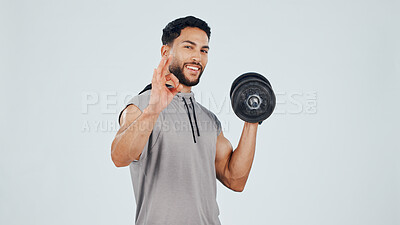 Buy stock photo Man, OK sign and dumbbell in studio for fitness approval, feedback or review with gesture for weightlifting. Vote, person and portrait with weights for muscle growth, agreement and background space