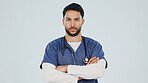 Pride, portrait or doctor in studio with arms crossed, ambition or about us in medical industry. Healthcare, space or man with confidence, career growth or wellness practitioner on white background.